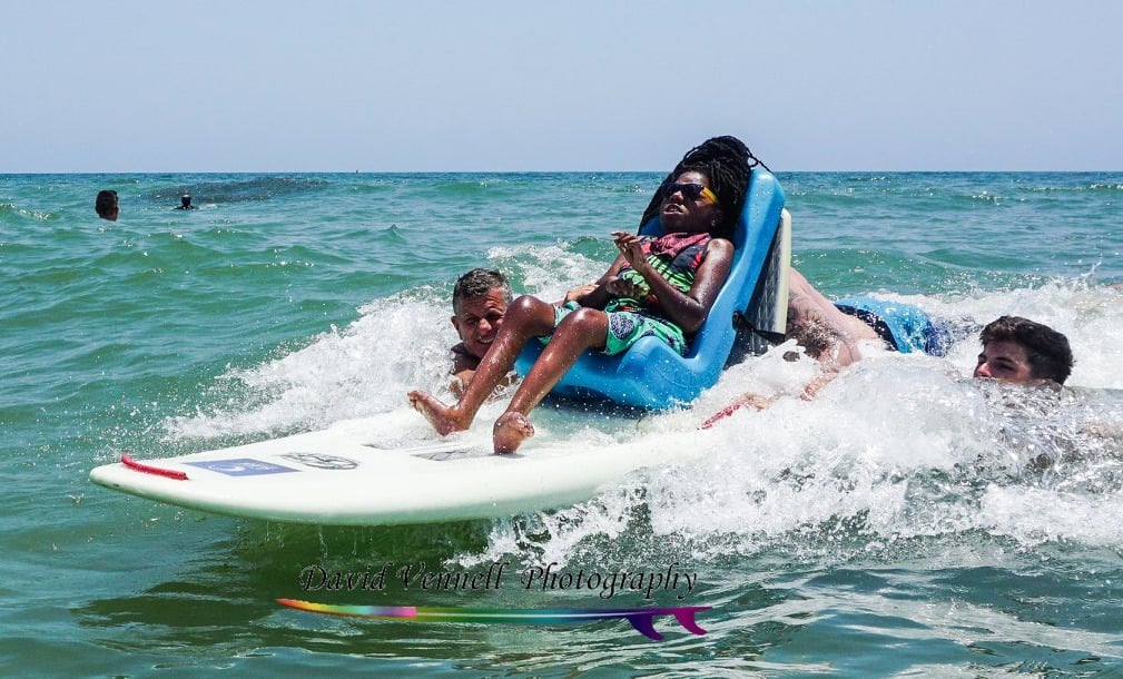 adaptive surfer riding seated